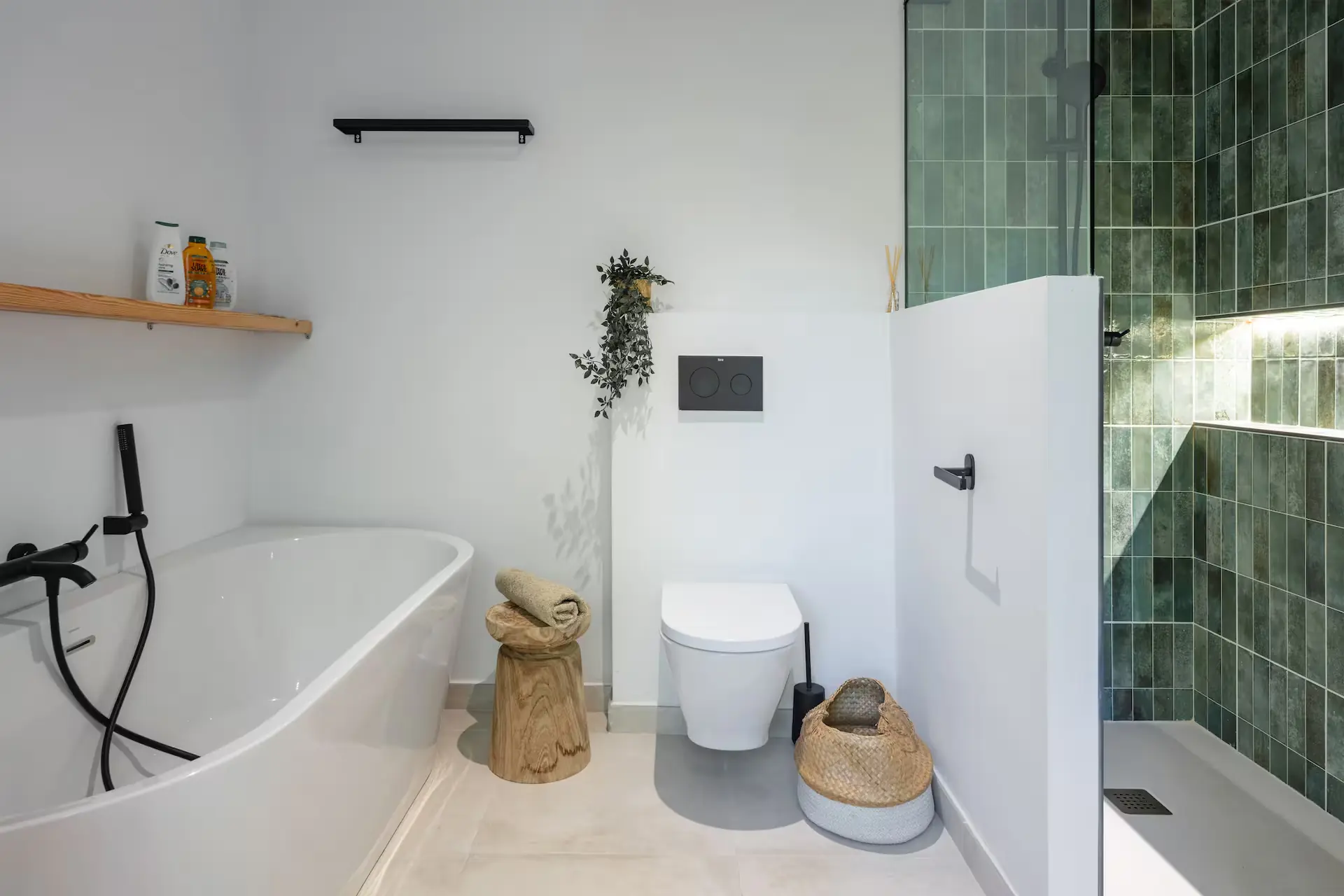 Bathroom with green tiles, a bathtub and a walk-in shower