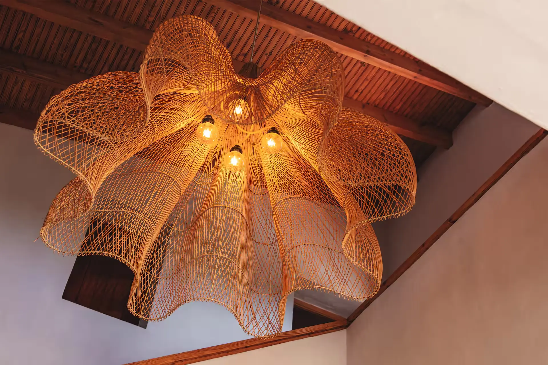 Rattan pendant lamp against the wooden ceiling