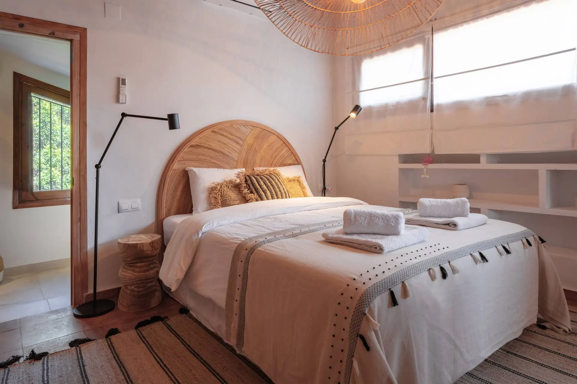 Bright bedroom with a wooden floor and a large window