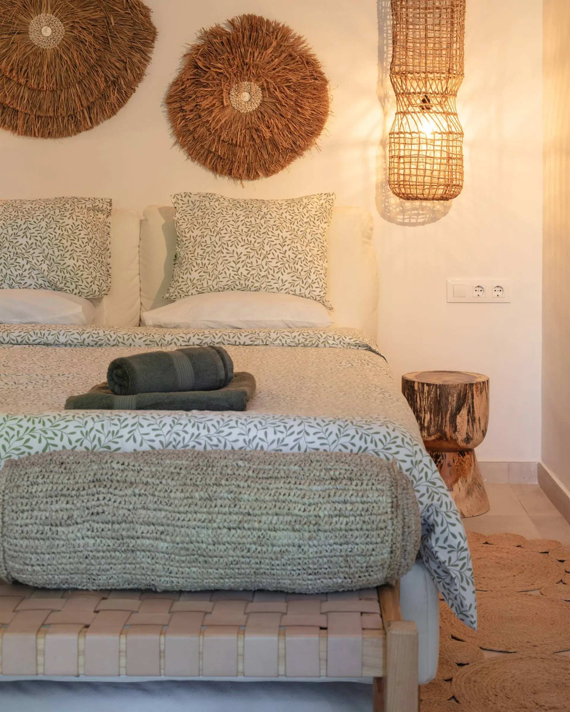 Bedroom with a double bed and rattan wall decoration