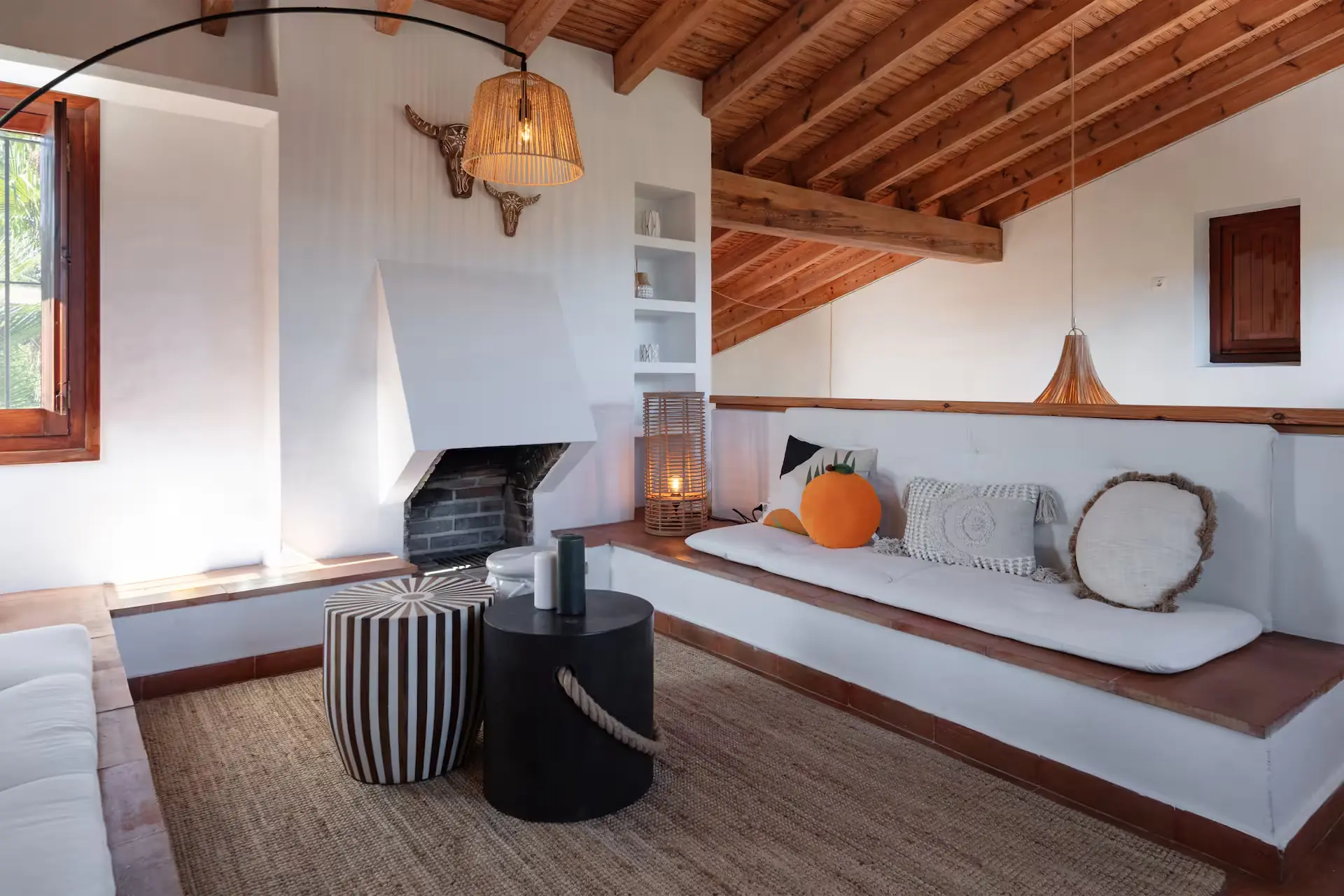Living room with a wooden beamed ceiling and an open fireplace