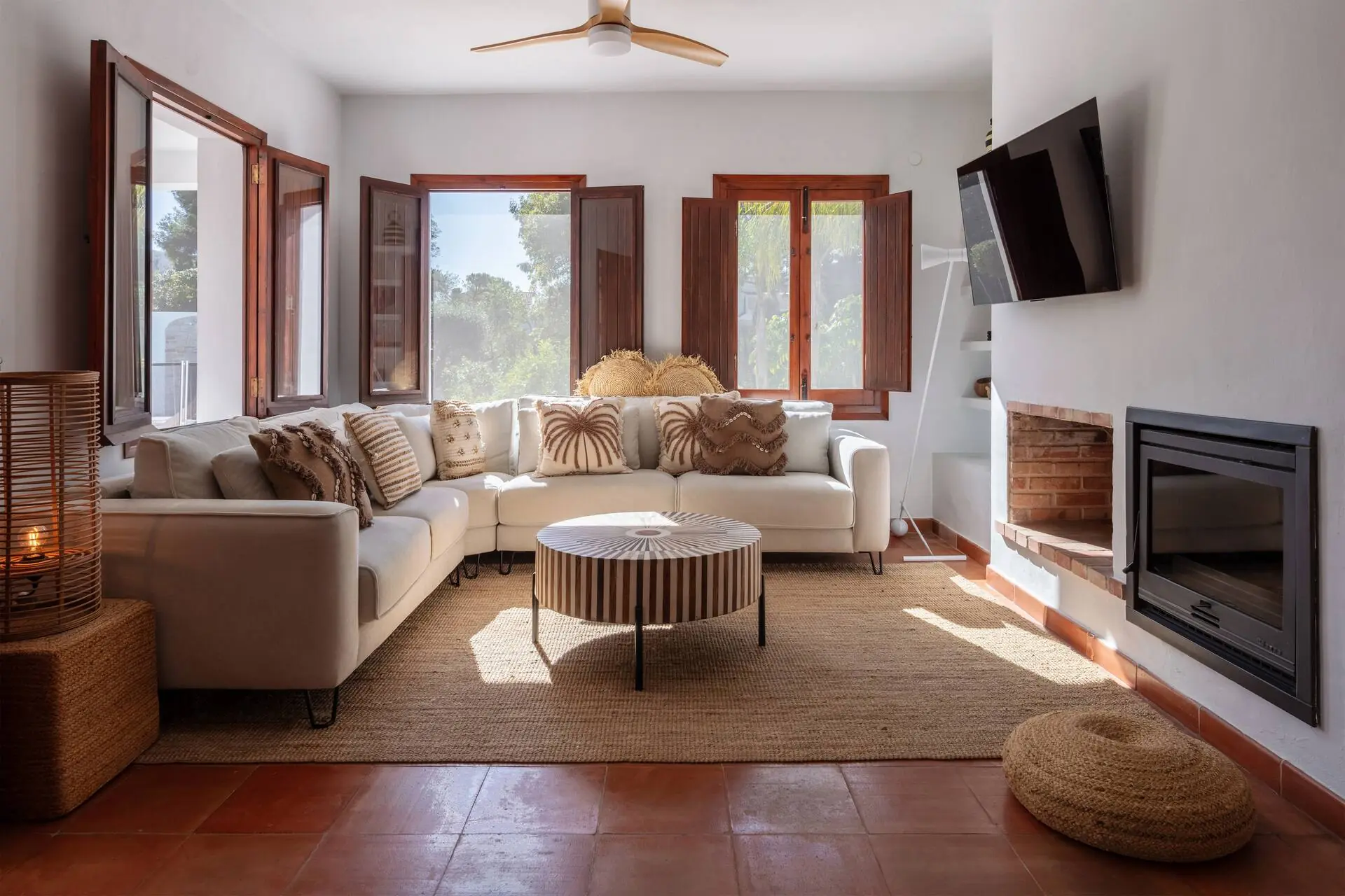 Bright living room with a corner sofa and large windows onto the garden